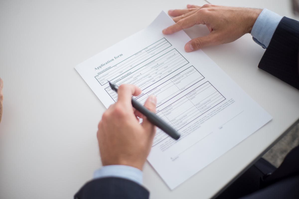 Professionnel examinant un formulaire de demande à un bureau